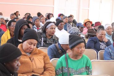 Group of people sitting attentively indoors.