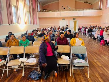 Community members gathered in a hall.