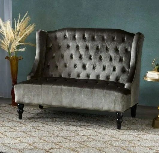 silver-green metallic high back loveseat with tufted backrest and a shag rug