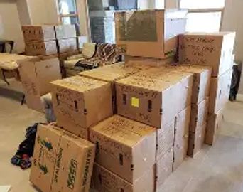Stack of packed cardboard boxes in a room.