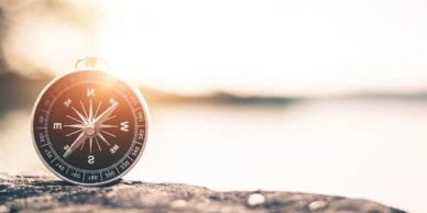 Compass on a rock with blurred background in sunlight, internal compass, find your way