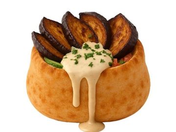 Fried eggplant in fluffy Middle Eastern pita, topped with creamy tahini, herbs, and fresh veggies