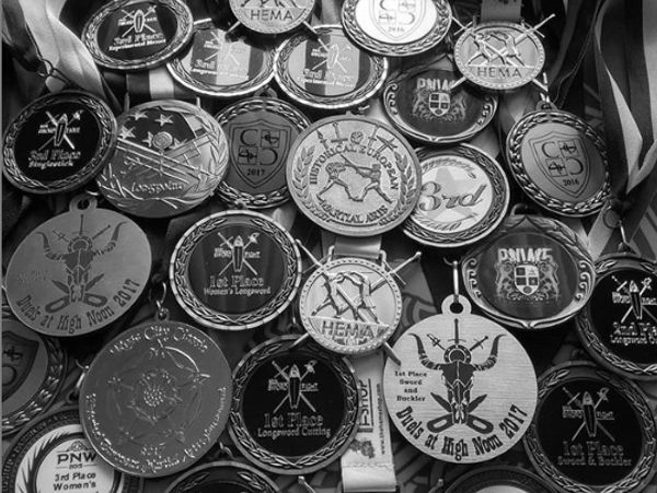 Collection of various medals from sword fighting competitions.
