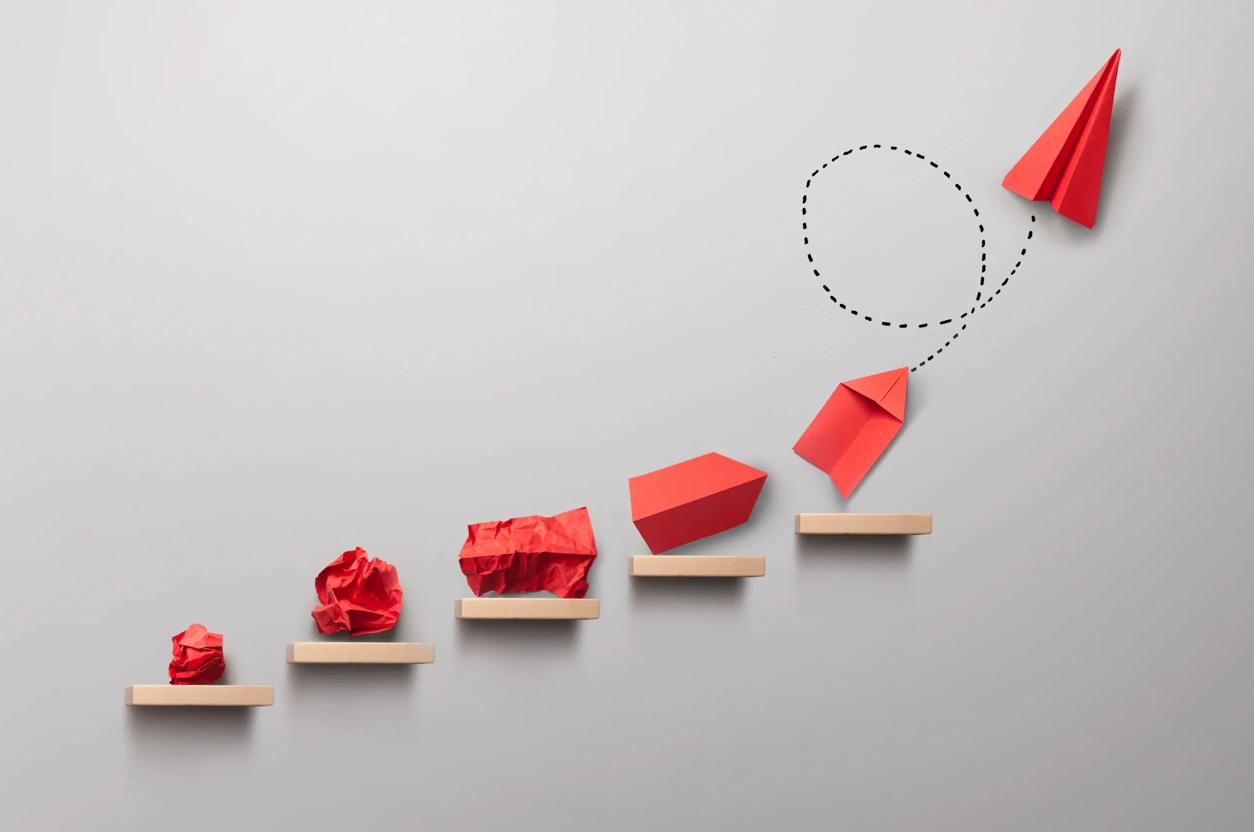 Paper planes evolving from crumpled paper to flying high.