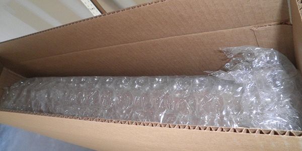 Cardboard box with bubble wrap inside.