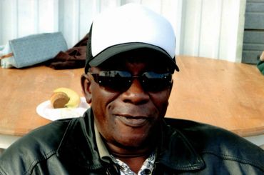 A man wearing a cap and sunglasses