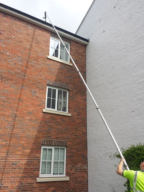 Gutter clearing on a 3-storey apartment block using a gutter vacuum system.