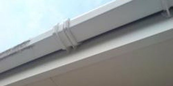 before and after cleaning picture of a UPVC gutter