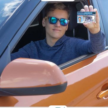 Young man in sunglasses holding up a driver's license from a car window.