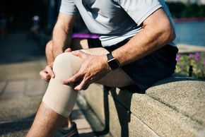 man sports injury knee bandage pain