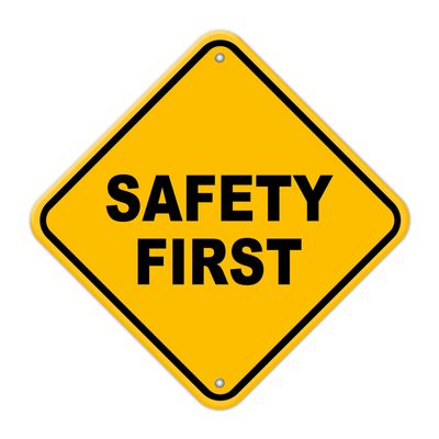 Yellow diamond-shaped sign with 'Safety First' in bold black letters.
