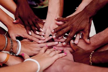 Diverse hands joined together in unity.