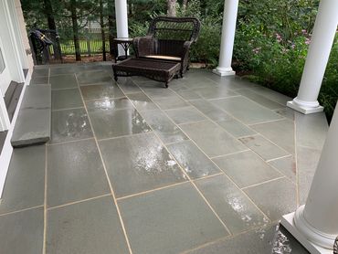 Elegant patio surrounded by comfortable seating and greenery.