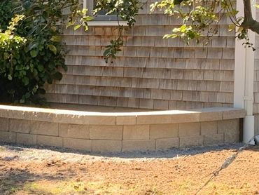 Custom designed retaining wall built to curve around natural landscape.