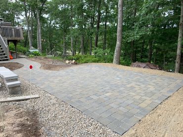 Patio with a decorative stone pathway leading to a garden area.