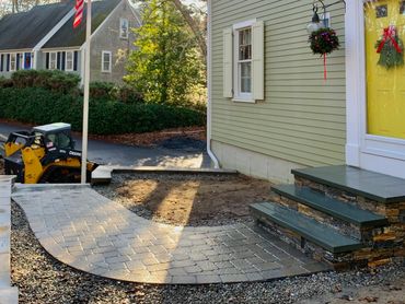 Custom designed pathway lead to a stone veneer steps.