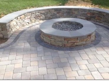 Spacious stone patio with outdoor seating area and fire pit.