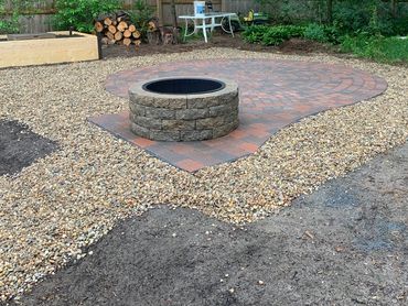 Family-friendly patio near play area and durable stone encompassing beautiful custom pavers.