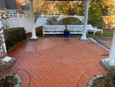 Brick patio with a pergola, outdoor dining and cozy seating area.