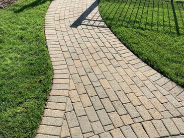Gorgeous pathway leads inside the fenceline of the owners property. A beautiful welcome home.