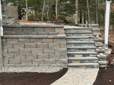 Custom retaining wall with stone veneer steps.
