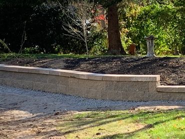 Custom designed retaining wall built to curve around natural landscape.