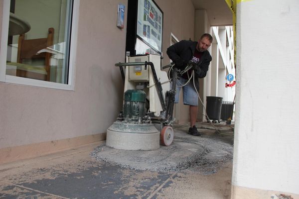 Old glue, paint and epoxy removal on walkway by Floor Rescue in uptown Dallas' West Village