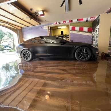 Brown metallic epoxy with wood grain look in garage with Tesla