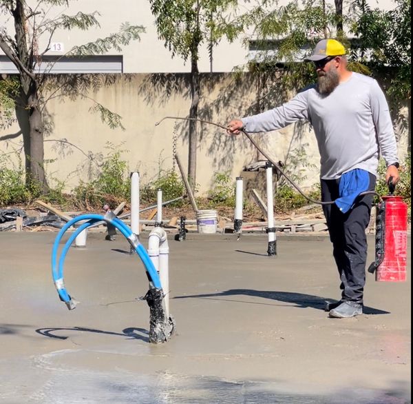 Jeremy spaying densifier and advanced cements additive for new concrete slab for residence in Dallas