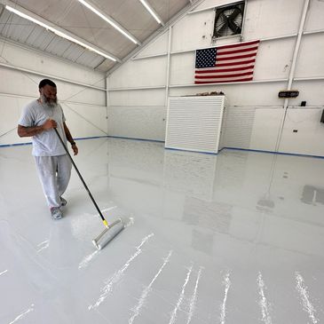 Epoxy application of resin flake floor systems in garages, airplane hangars, laboratories, bathrooms