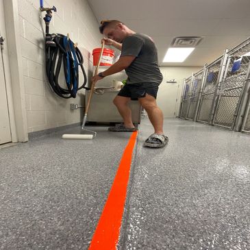 Topcoat application of polyaspartic coating over epoxy flake floors in vet clinic, commercial labs