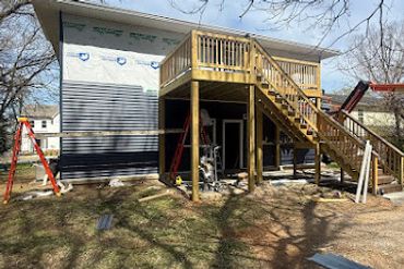 A house with a newly constructed wooden deck and staircase.