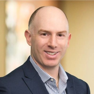 Smiling bald man in a suit.