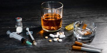 Cigarettes drugs alcohol are placed on a table