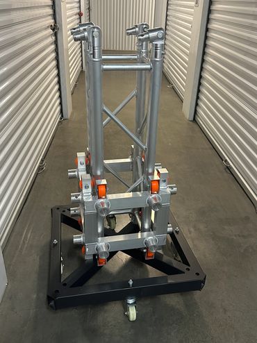 Metal truss structure on a rolling base in a storage hallway.
