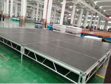 Large industrial stage platform inside a spacious factory.