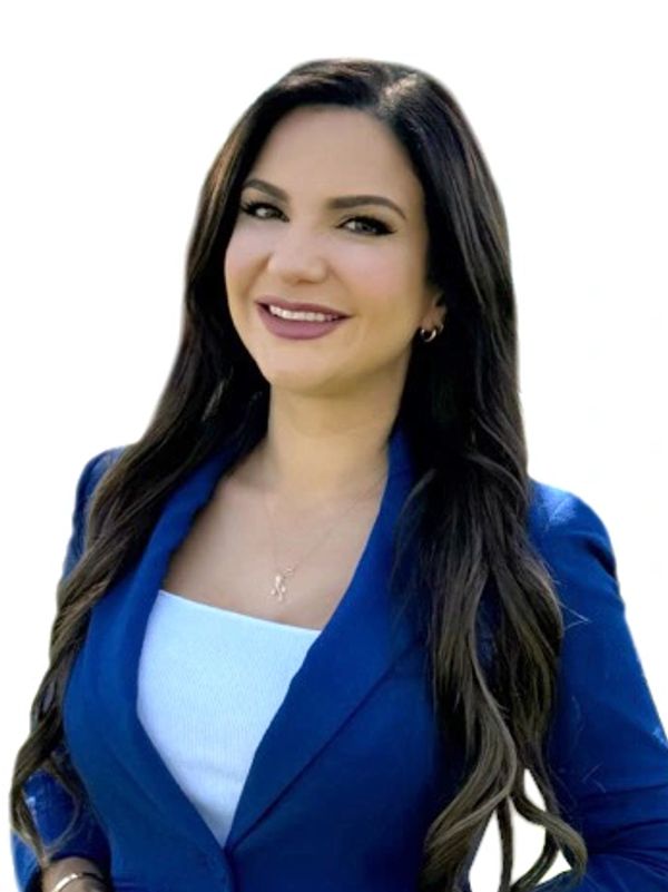 Confident woman with long dark hair wearing a blue blazer and white top.