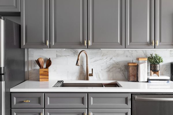 Modern grey kitchen cabinets, backsplash.