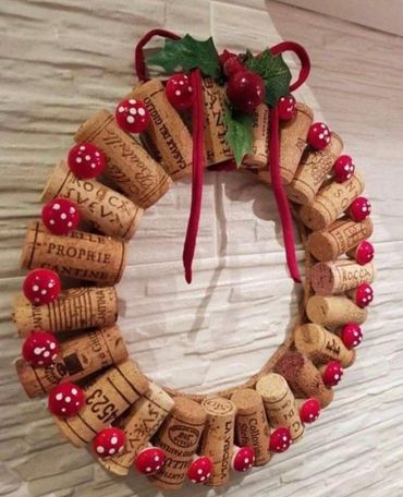 A decorative wreath made from wine corks and small red mushrooms with white spots.