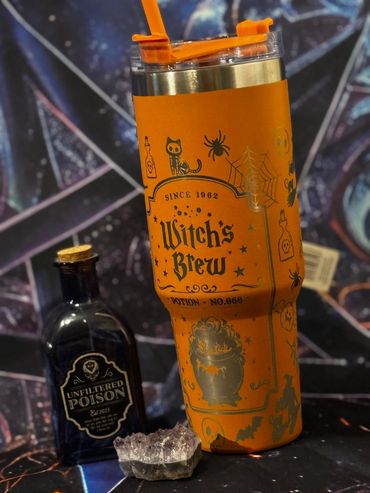 Halloween-themed drinkware and potion bottle with a crystal.