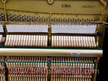 Interior mechanics of a Yamaha U30A piano.