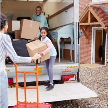 Family unloading boxes from a moving truck.