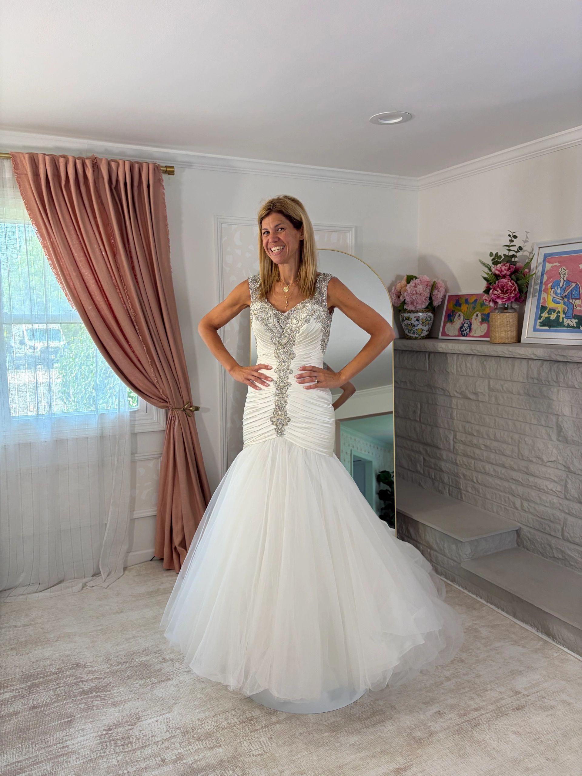 Woman in an elegant white dress smiling.
