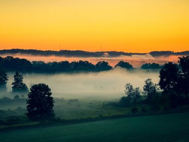 Morning fog in field sunrise