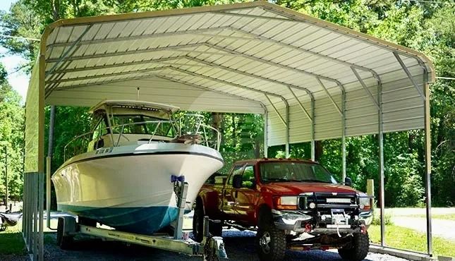 Boat and red pickup truck parked under a metal carport.