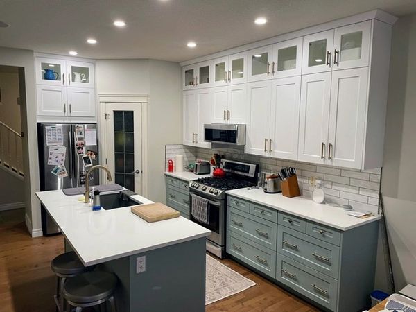 green and white kitchen, glass doors, extra space.