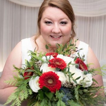 Bride holding her Christmas Inspired cascading wedding bouquet