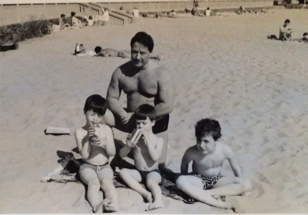 APOLLO & THELMA: MIGHTY APOLLO WITH HIS SONS, MARK, BRUCE & PAUL. PHOTO ST KILDA BEACH 1969