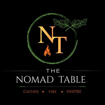 Logo of The Nomad Table with nature and fire elements.
