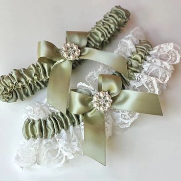 Elegant green satin and lace garters with pearl and rhinestone bows.